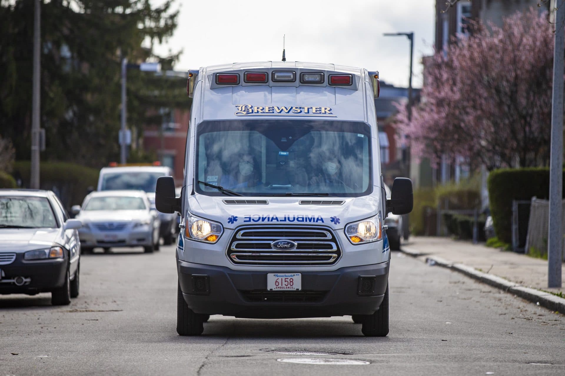 The BMC mobile pediatrician unit slowly drives down a Dorchester street looking for the house where they will conduct an exam of a 1-year-old boy. (Jesse Costa/WBUR)