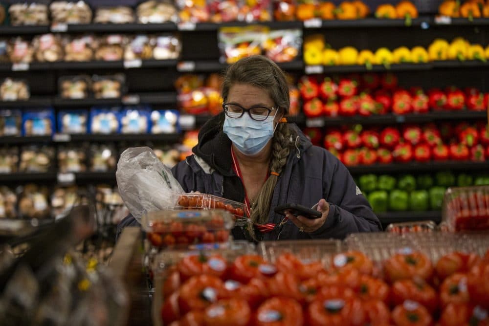 Woodford, scanning produce into the Instacart app as she shops. (Jesse Costa/WBUR)