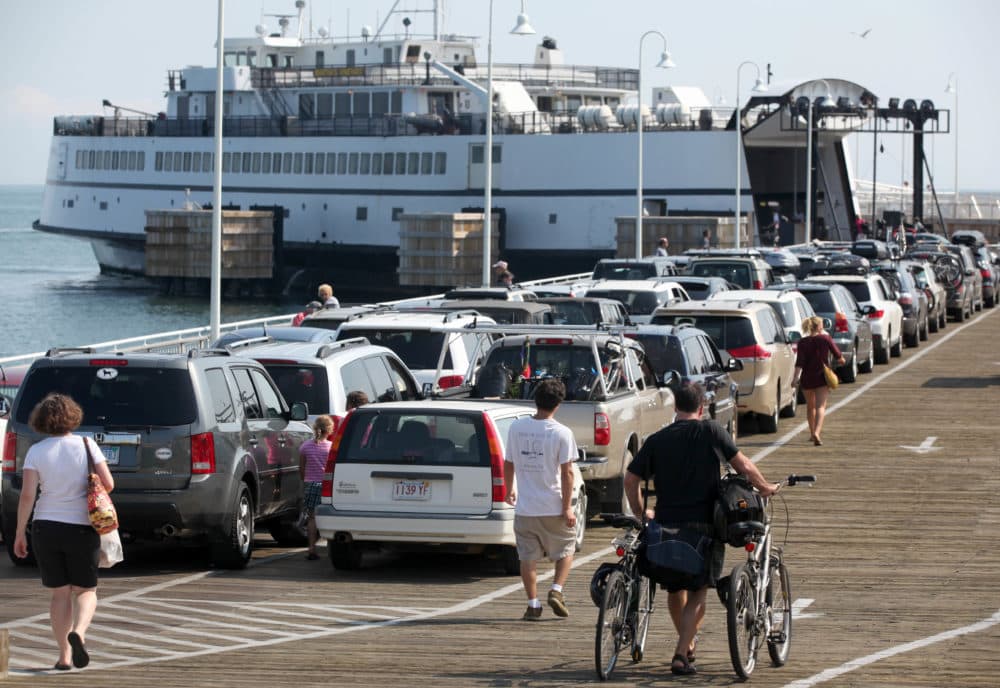 Passengers with cars and bicycles prepare to board a ferry departing the island of Martha's Vineyard, in Oak Bluffs, Mass. (Steven Senne/AP)
