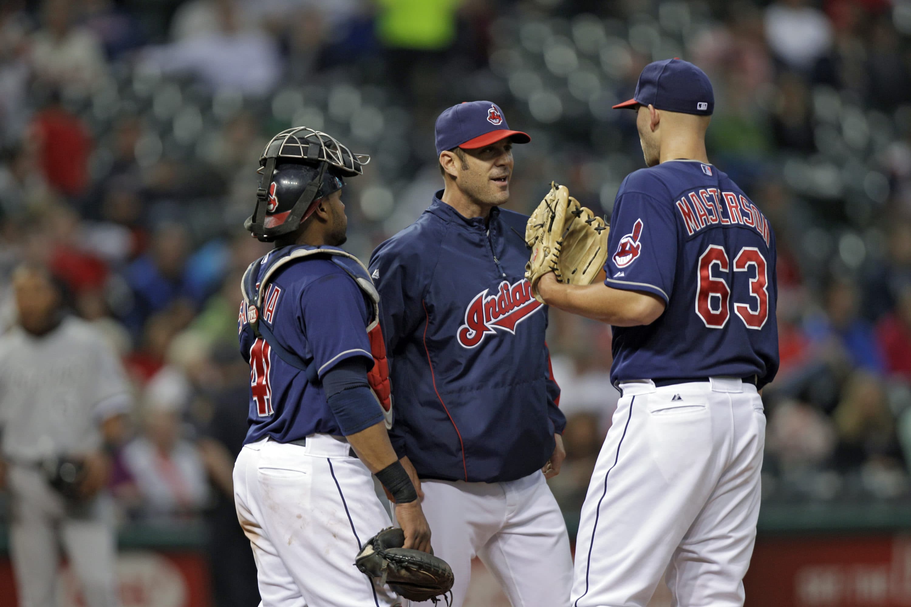 Cleveland Indians pitching coach Scott Radinsky, center, makes a mound visit on May 8, 2012. (Mark Duncan/AP)