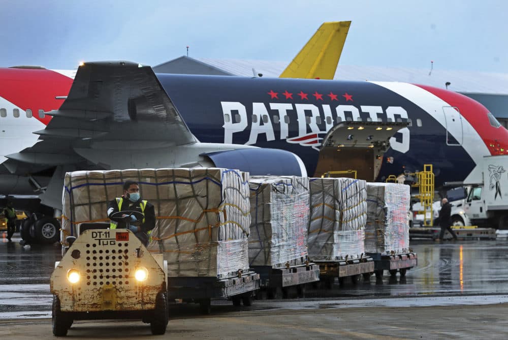 Palettes of N95 respirator masks are off-loaded from the New England Patriots football team's customized Boeing 767 jet on the tarmac, Thursday, April 2, 2020, at Boston Logan International Airport in Boston, after returning from China. The Kraft family deployed the Patriots' team plane to China to fetch more than 1 million masks for use by front-line health care workers to prevent the spread of the new coronavirus. (Jim Davis/The Boston Globe via AP, Pool)