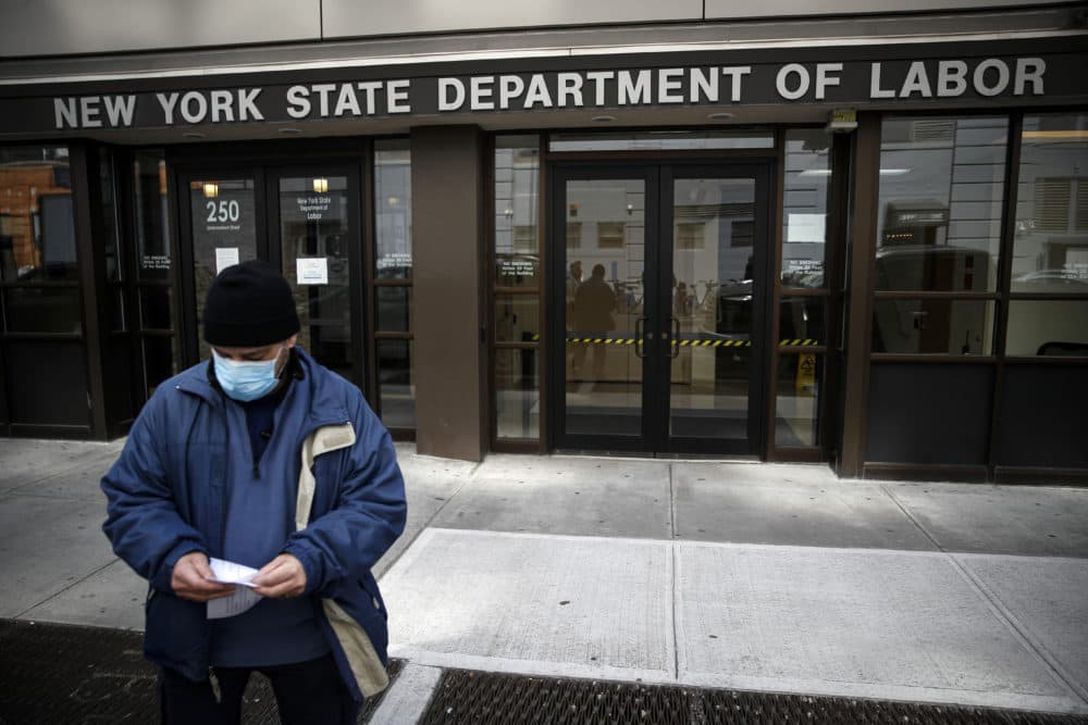 Visitors to the Department of Labor are turned away at the door by personnel due to closures over coronavirus concerns in New York. Americans are seeking unemployment benefits at unprecedented levels due to the coronavirus, but many are finding more frustration than relief. (John Minchillo/AP)