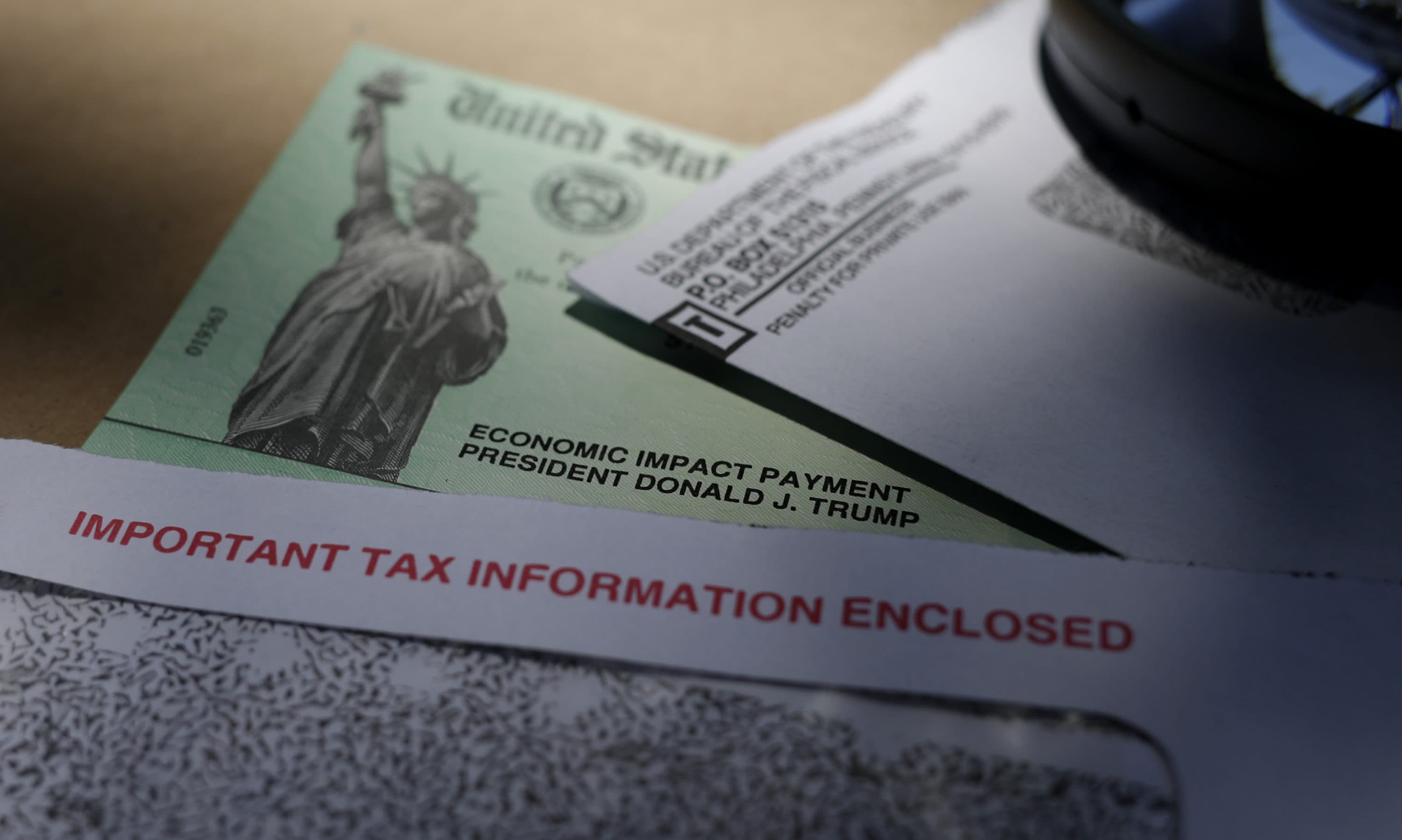 President Donald Trump's name is seen on a stimulus check issued by the IRS to help combat the adverse economic effects of the COVID-19 outbreak, in San Antonio, Thursday, April 23, 2020. According to the Treasury Department, it marks the first time a president's name has appeared on any IRS payments, whether refund checks or other stimulus checks that have been mailed during past economic crises. (AP Photo/Eric Gay)