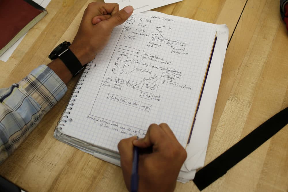 A student writes notes in the Advanced Placement (AP) Physics class at Woodrow Wilson High School in Washington, (Charles Dharapak/AP)