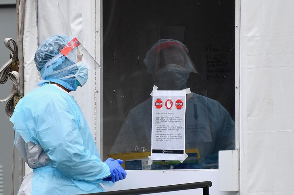 A medical worker stands outside a COVID-19 screening tent in New York City. (Angela Weiss/AFP/Getty Images)