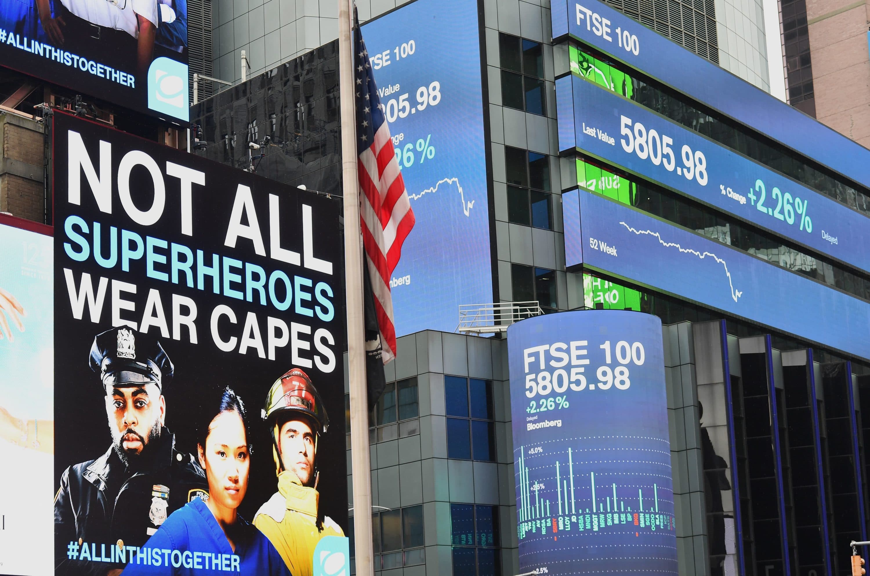 Digital billboards and a US Flag at half-mast at Time Square on April 09, 2020 in New York City. (ANGELA WEISS/AFP via Getty Images)