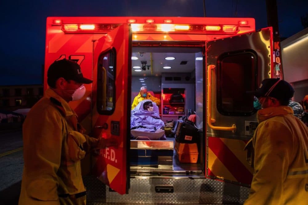 Paramedics wear a face mask as a preventive measure against the spread of COVID-19. (Apu Gomes/AFP/Getty Images)
