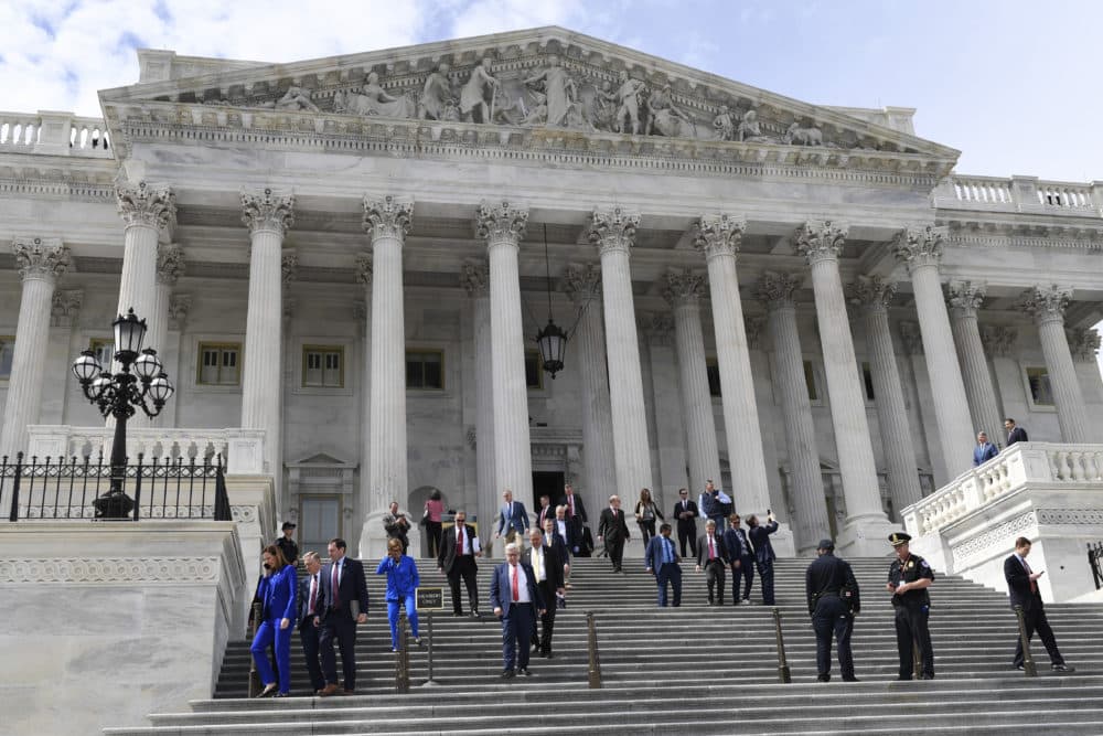 Members of the House of Representatives walk down the steps of Capitol Hill in Washington on March 27 after passing a coronavirus rescue package. (Susan Walsh/AP)