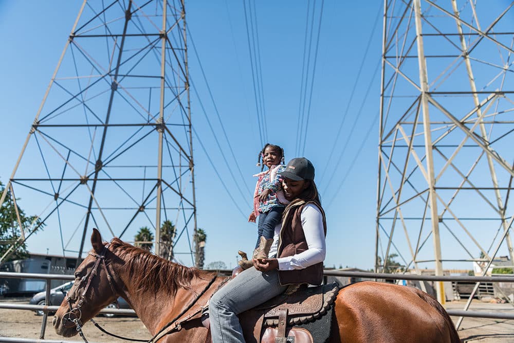 Keiara and her daughter ride around (Photo by Walter Thompson-Hernández)