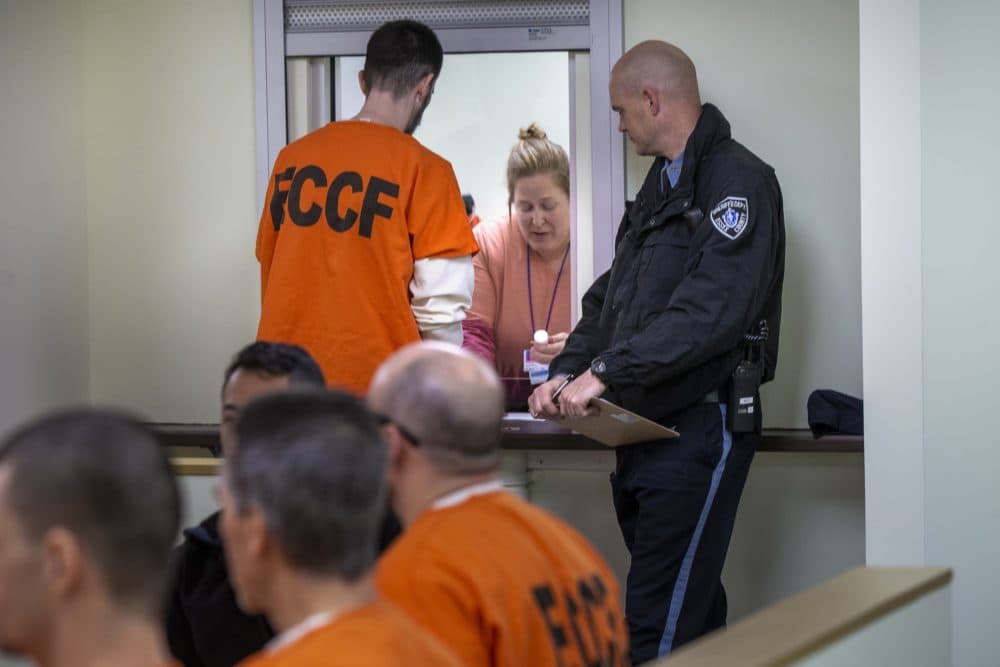 An inmate at Essex County House of Correction receives medication in the medical unit months before the coronavirus pandemic in Massachusetts hit. (Jesse Costa/WBUR)