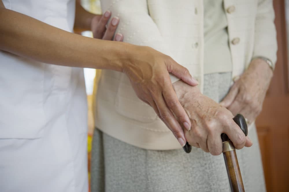 Close up of health care worker helping an older woman walk. (Jacobs Stock Photography Ltd/Getty Images)