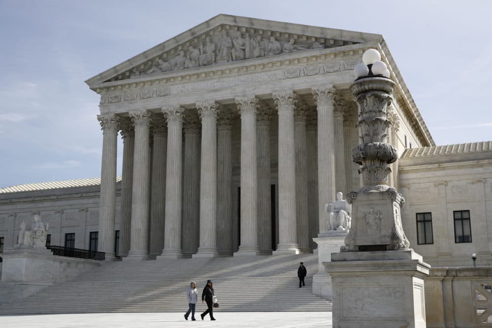 In this March 16 photo, people walk outside the Supreme Court in Washington. (Patrick Semansky/AP)
