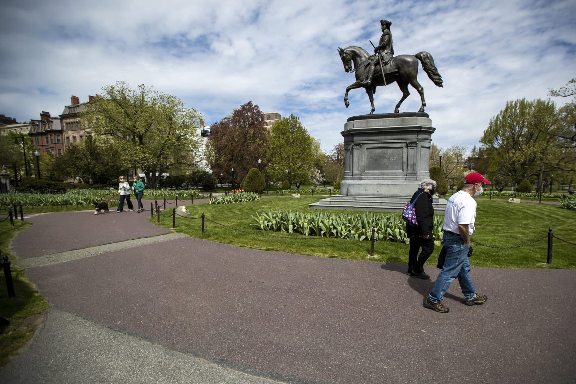 People walk around the statue of George Washington in the Boston Public Garden. (Jesse Costa/WBUR)