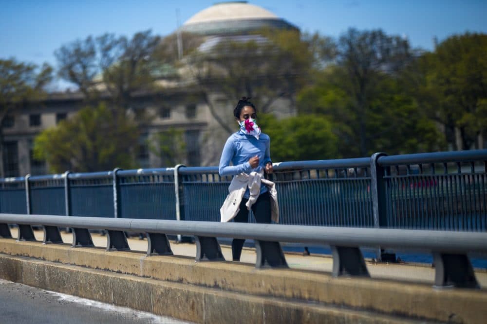 A woman runs across the Massachusetts Avenue Bridge. (Jesse Costa/WBUR)