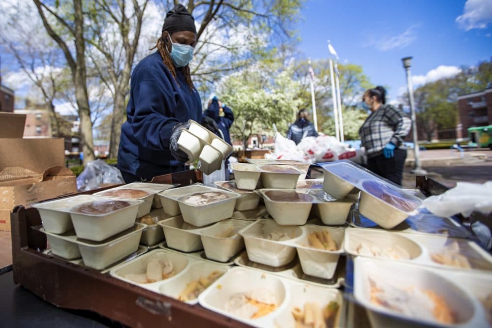 BHA employee Bonnie Jones bags up youth meals of turkey sandwiches and pasta salad to be distributed at the Mary Ellen McCormack development in South Boston. (Jesse Costa/WBUR)