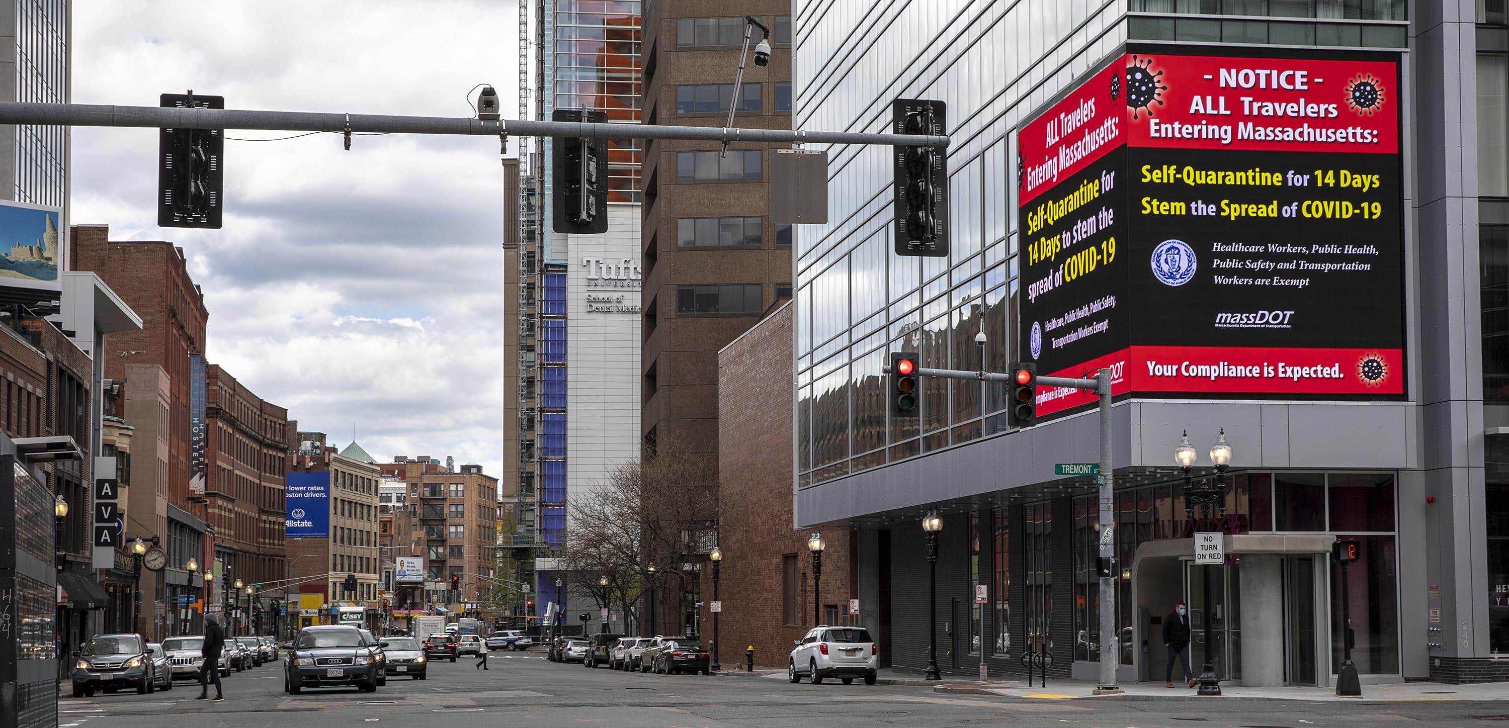 A sign on Tremont Street urges travelers to Boston to quarantine for 14 days. (Robin Lubbock/WBUR)