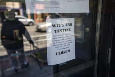 A sign on the door of Wit’s End informing people they are closed. The Cambridge bar was offering COVID-19 antibody testing, but then the city ordered it shut down. (Jesse Costa/WBUR)