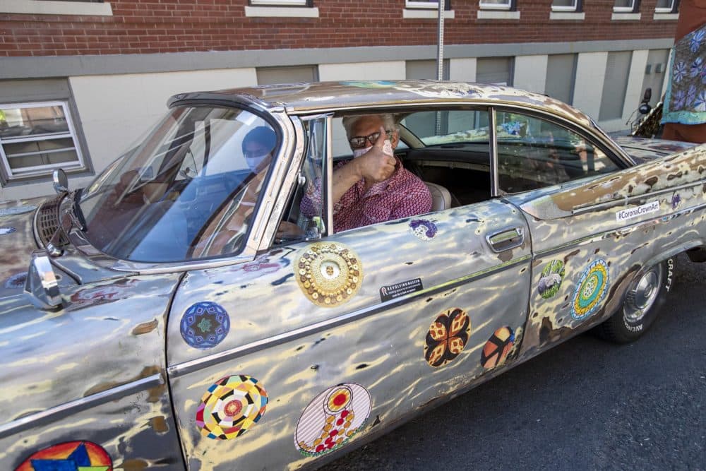 Jerry Beck gives a thumbs up as he drives the CoronaCrown Art Project towards Bellingham Square. (Jesse Costa/WBUR)