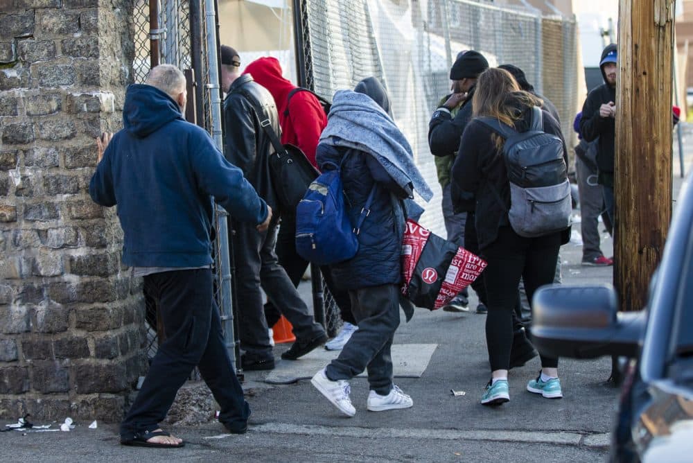 People file into a tent being used as an "engagement center" outside the public shelter at 112 Southampton Street, Boston, in May 2020. (Jesse Costa/WBUR)