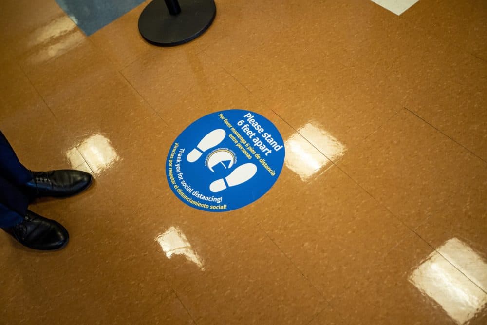 New stickers dot the floors at the East Boston Neighborhood Health Center to make sure patients maintain a safe distance while waiting to be ushered into an exam room.(Jesse Costa/WBUR)