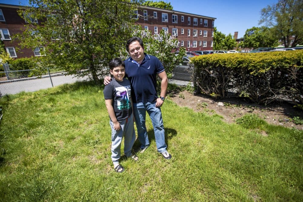Dimas Molina and his son, Chris, at the Faneuil Gardens housing development in Brighton. (Jesse Costa/WBUR)
