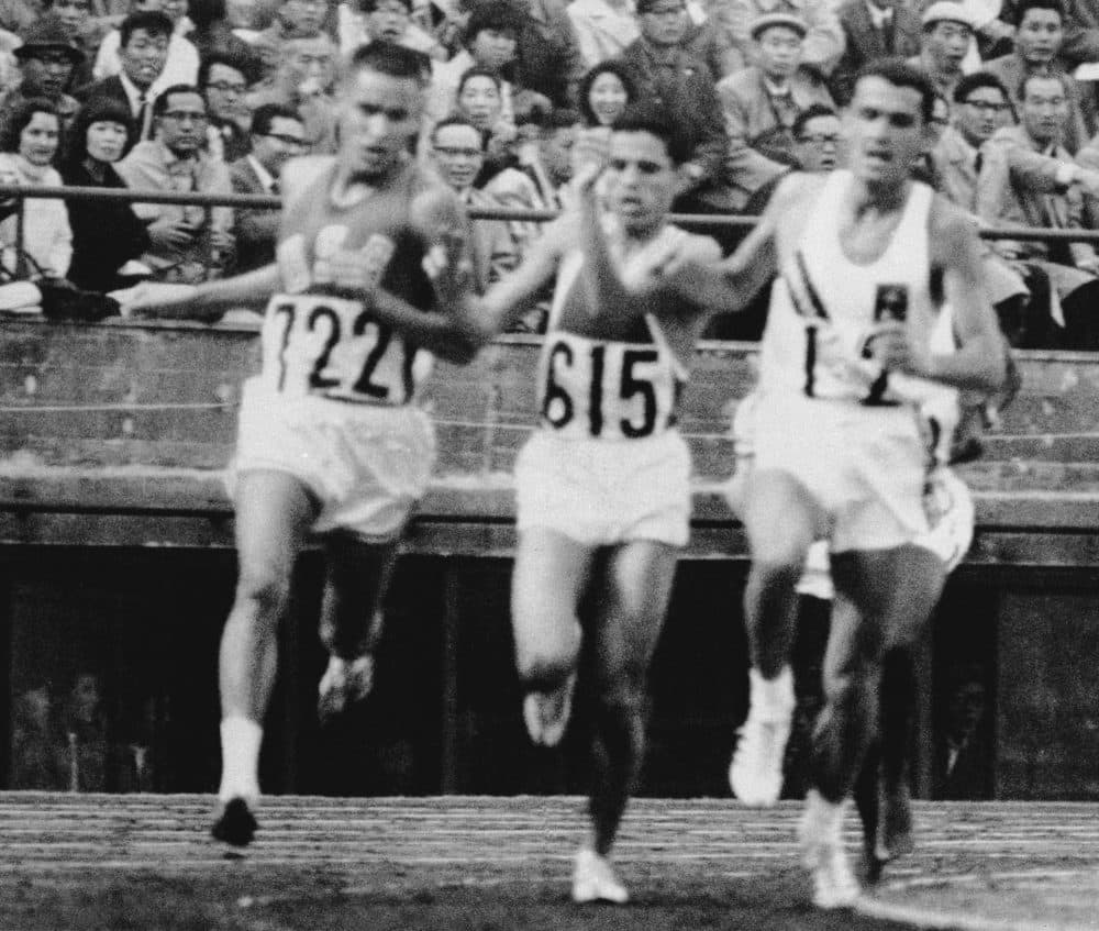 Billy Mills (left), Mohammed Gammoudi (center) of Tunisia and Ron Clarke (right) of Australia leading Mills in the 10,000-meter race. (AP)