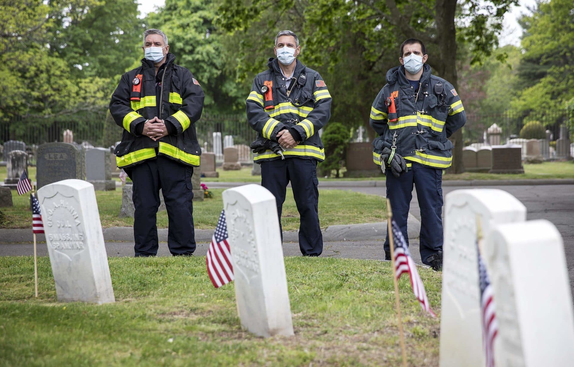 Three members of the Everett Fire Department attend a Memorial Day service in Glenwood Cemetery, Everett. (Robin Lubbock/WBUR)