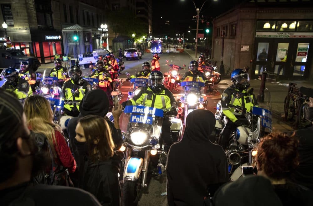 Police motorcycles block protestors way on Tremont Street. (Robin Lubbock/WBUR)