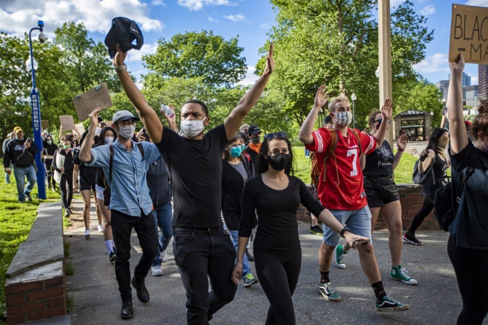 Protesters coming from the State House walk through the Boston Common toward Nubian Square to meet other protesters. (Jesse Costa/WBUR)