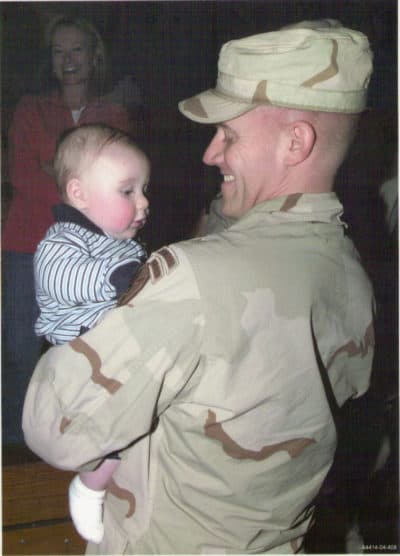 Army Maj. Paul Voelke holds his son. (Courtesy)