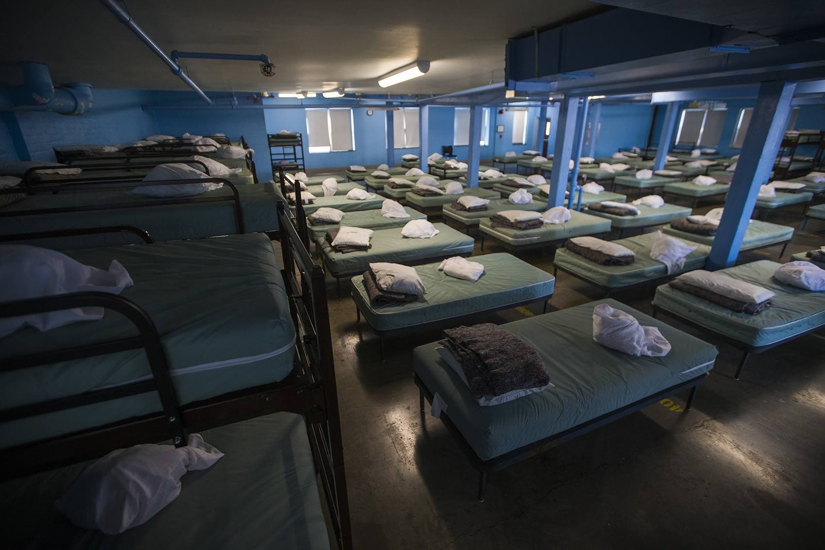 Beds in the men's dorm at Pine Street Inn, photographed in 2018. In response to the pandemic, shelter workers installed plastic curtains between the beds and were able to put more distance between them after some guests were moved into a Suffolk University dorm or went into isolation because of the coronavirus. (Jesse Costa)