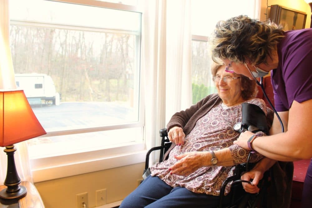 A nurse helps a patient at Shady Oaks Assisted Living. (Courtesy of Tyson Belanger)