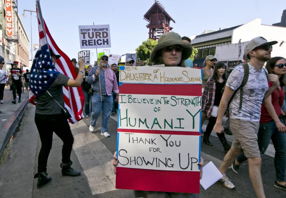 Demonstrators march in downtown Los Angeles on Sunday, Aug. 13, 2017. Protesters decrying hatred and racism converged around the country Sunday, the day after a white supremacist rally that spiraled into violence in Charlottesville, Va. (Damian Dovarganes/AP)