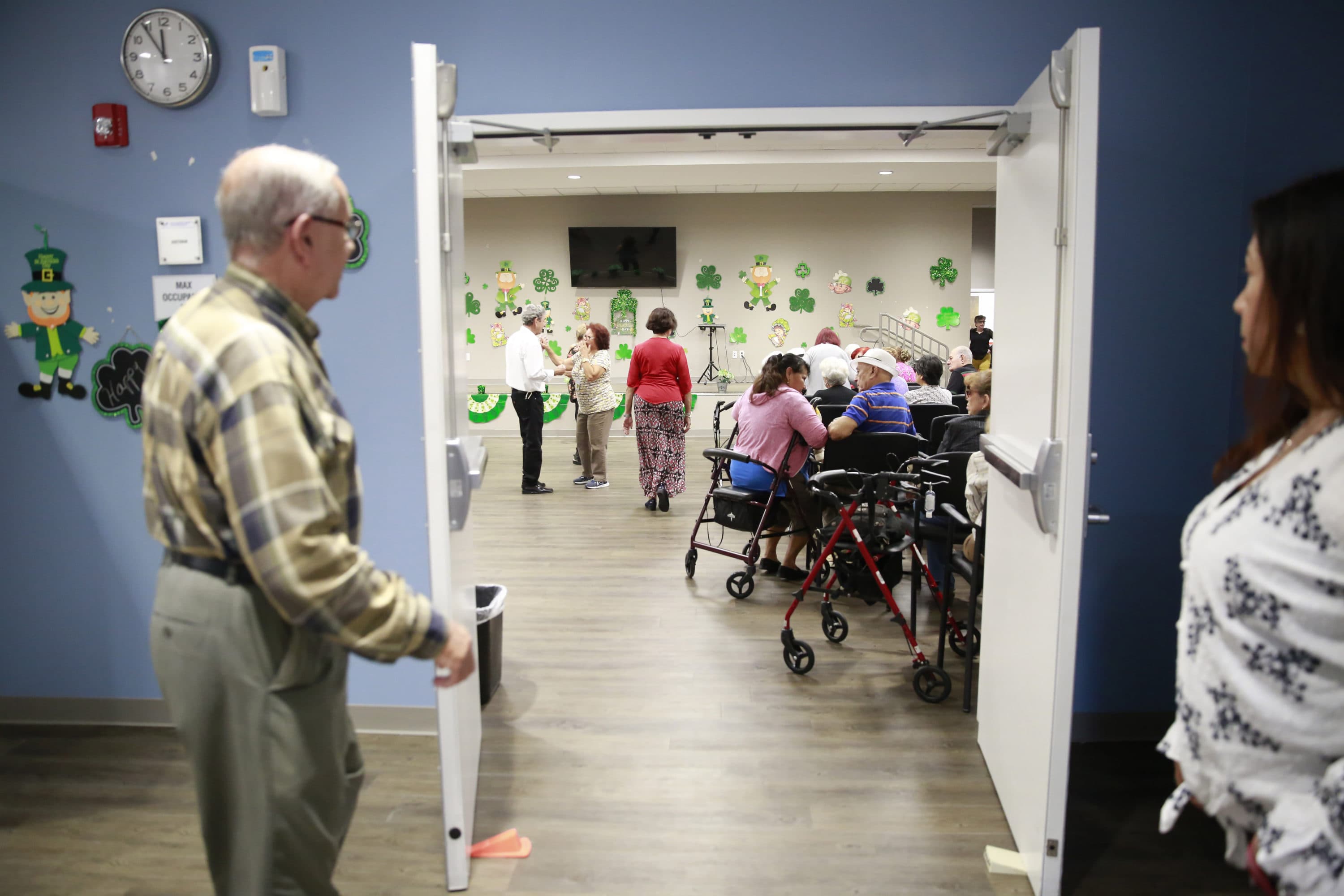 Seniors gather in an auditorium for morning announcements at Little Havana Activities and Nutrition Centers of Dade County, Inc., in Miami. (AP Photo/Brynn Anderson)