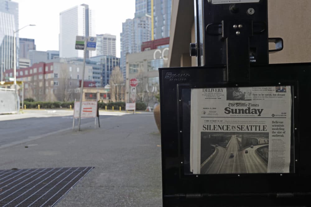 The street next to a Seattle Times newspaper box in front of the building that houses the Times' newsroom is empty, Sunday, March 15, 2020 in Seattle, as the headline &quot;Silence in Seattle&quot; is displayed. (Ted S. Warren/AP Photo)