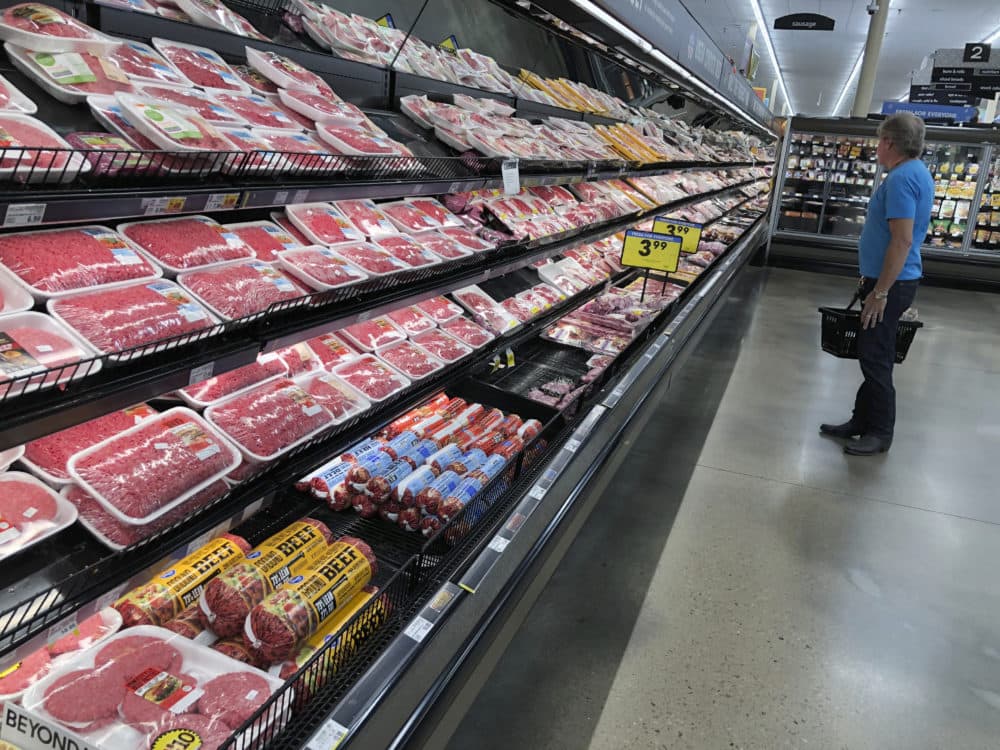 A shopper surveys the overflowing selection of packaged meat in a grocery early Monday, April 27, 2020, in southeast Denver. (David Zalubowski/AP)