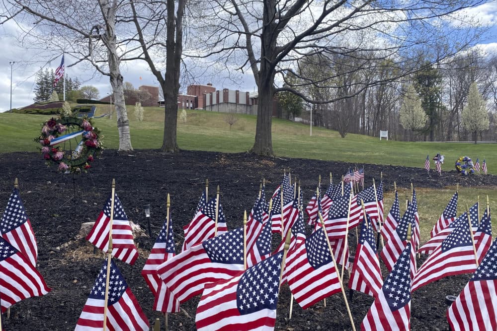 Flags and wreaths honor veterans, Tuesday, April 28, 2020, on the grounds of the Soldiers' Home in Holyoke, Mass., where a number of people died due to the coronavirus. (Rodrique Ngowi/AP)