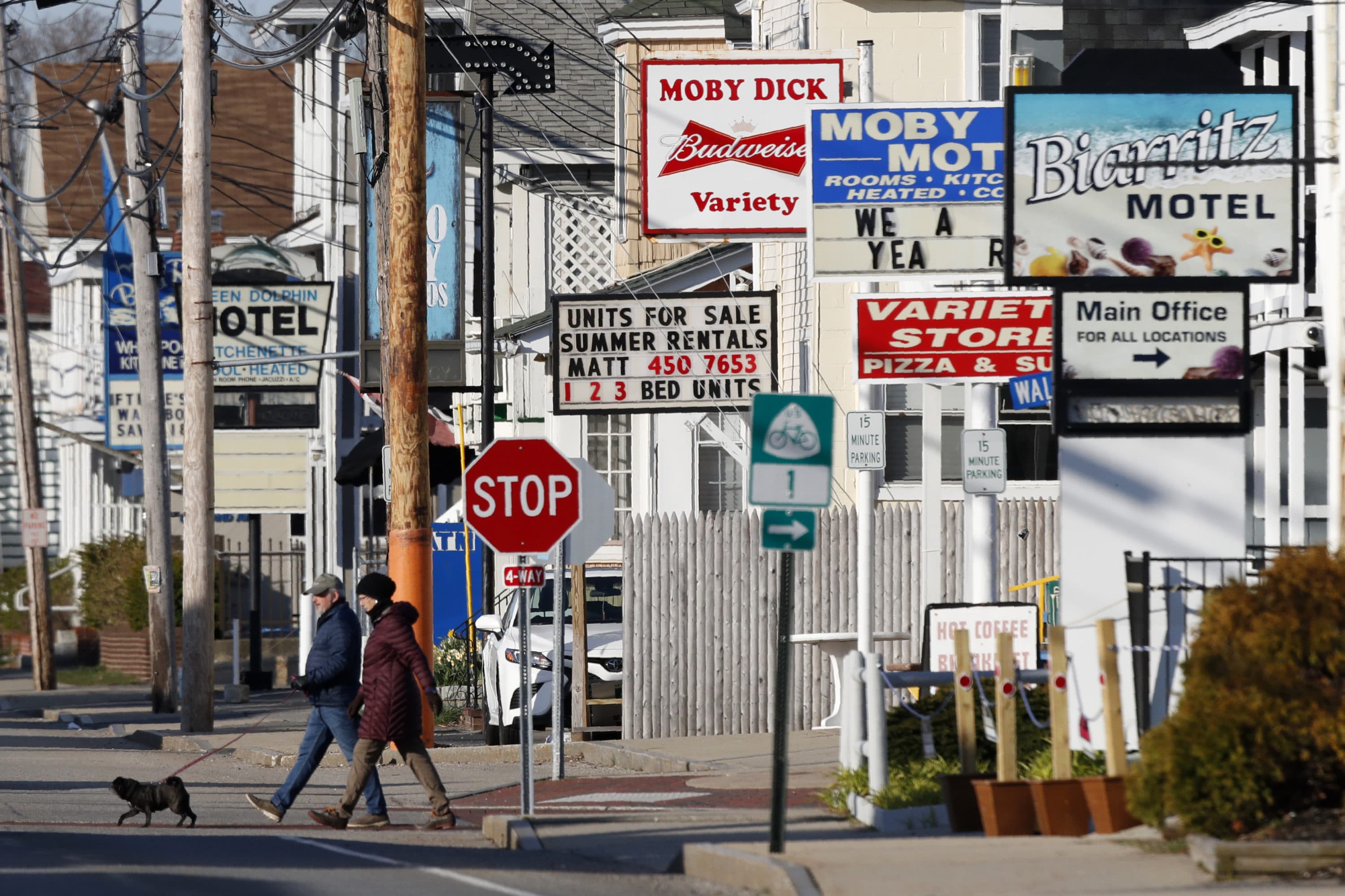 A couple walks by a row of closed motels, Wednesday, April 29, 2020, in Old Orchard Beach, Maine. Gov. Janet Mills on Tuesday announced tentatives plans to allow for lodging, campgrounds and the reopening of bars on July 1. (Robert F. Bukaty/AP)