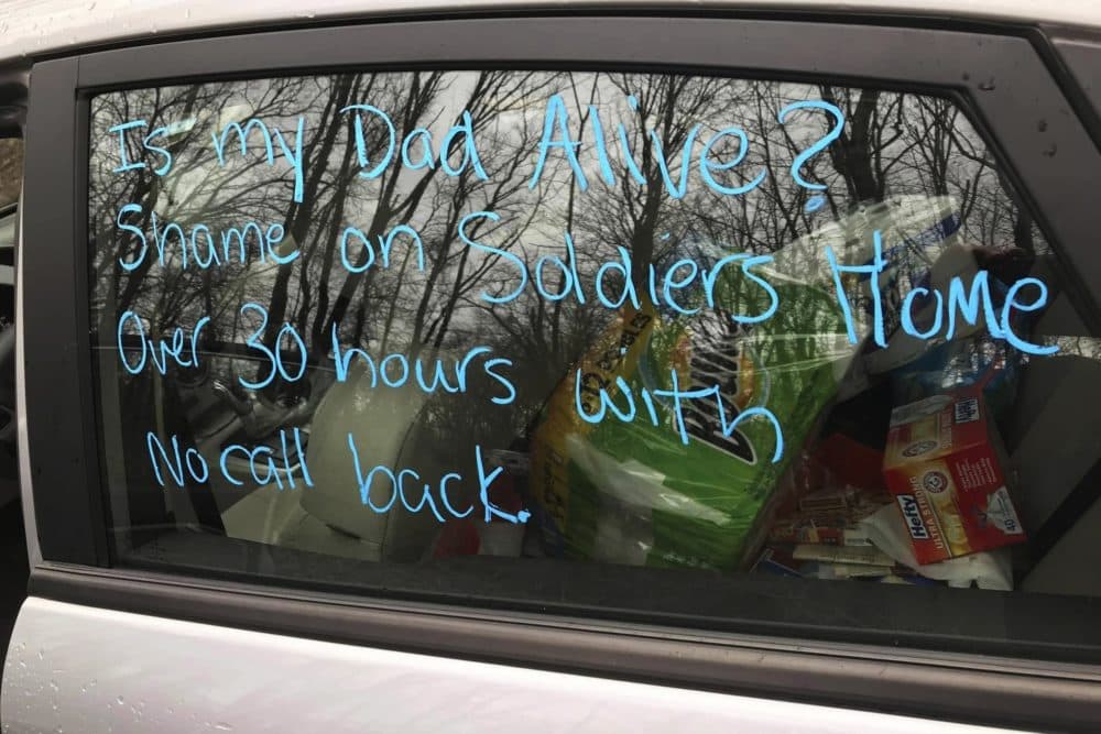 This recent provided by Susan Kenney shows a message written on the window of her car seeking information about her late father Charles Lowell, who had been residing at the Holyoke Soldiers' Home in Holyoke, Mass. Lowell died April 15, 2020, after contracting the new coronavirus while residing at the veterans' home. He was 78. (Susan Kenney via AP)