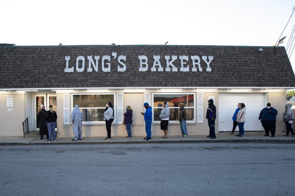 Customers wait in line at the Long's Bakery Shop in Indianapolis, Friday, May 1, 2020 after the bakery reopened after closing it doors due to COVID-19. (Michael Conroy/AP Photo)
