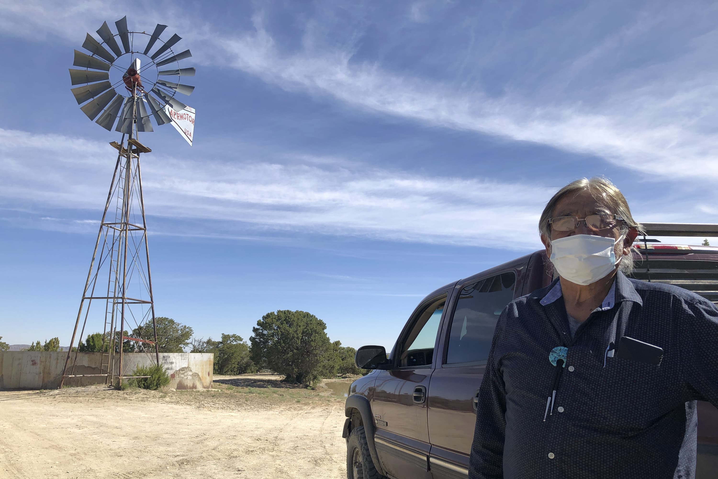 Johnnie Henry, president of the Navajo Nation's Church Rock chapter house community center, hauls drinking water to neighbors in Gallup, N.M., Thursday, May 7, 2020. Henry says that a lockdown at Gallup in response to the spread of the coronavirus came as a suprise to many Navajo Nation residents who depend on Gallup for supplies they can't access. (AP Photo/Morgan Lee)