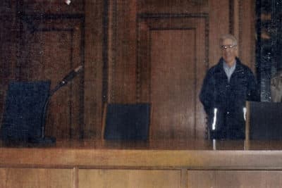 In this May 2000 family photograph provided by Emily DiPalma Aho, Emilio DiPalma stands in the spot where he stood guard as a 19-year-old U.S. Army infantryman at the Nuremberg Nazi war crimes trials. (Courtesy of Emily DiPalma Aho via AP)