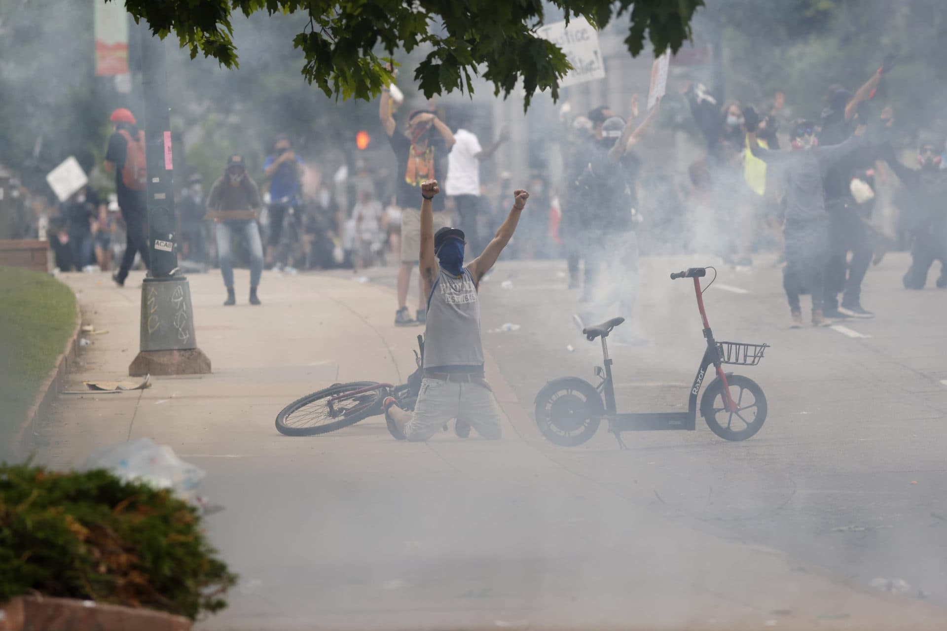 Tear gas fills the air after Denver Police fired canisters during a protest outside the State Capitol over the death of George Floyd, Saturday, May 30, 2020, in Denver. Protests were held in U.S. cities over the death of Floyd, a black man who died after being restrained by Minneapolis police officers on May 25. (AP Photo/David Zalubowski)