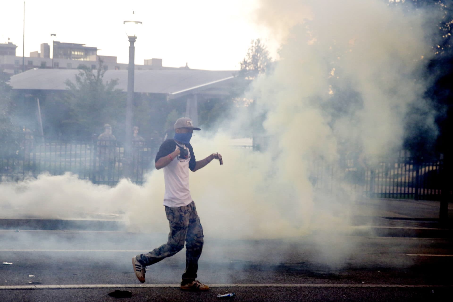 Demonstrators protest in a fog of gas that the Atlanta Police launched at a crowd, Saturday, May 30, 2020 in Atlanta. (AP Photo/Brynn Anderson)