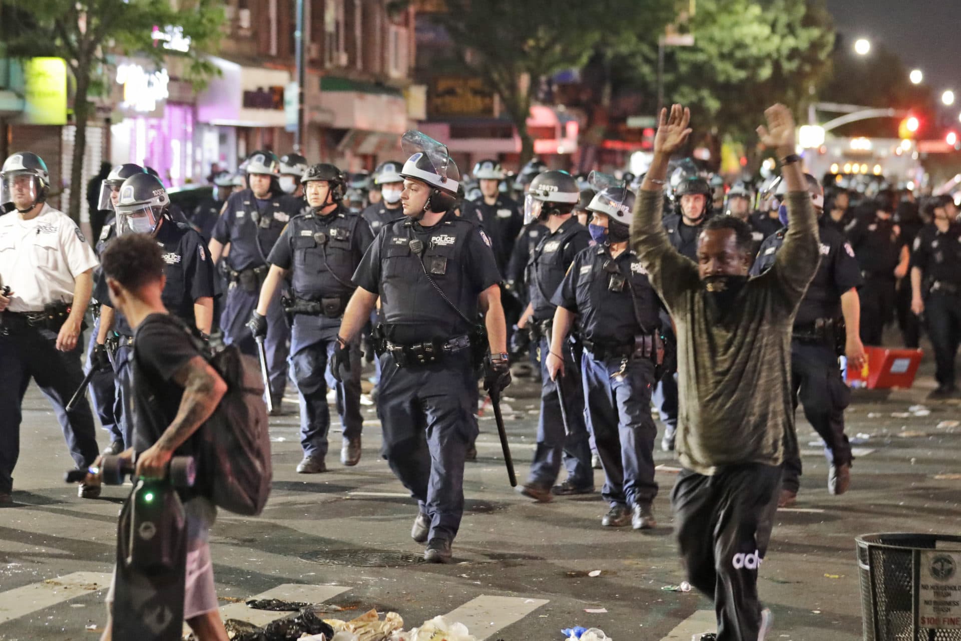 Police in riot gear walk down a street during protests in the Brooklyn borough of New York, Saturday, May 30, 2020. (AP Photo/Seth Wenig)
