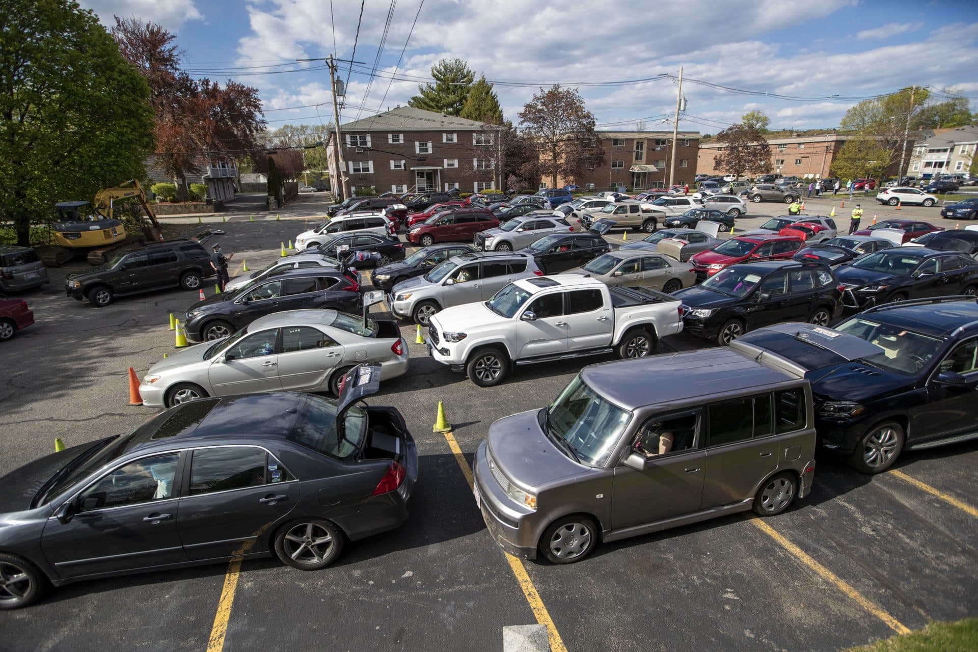 Cars waiting in line for food assistance. On that day, nearly 3,000 bags of groceries were passed out to families in need. (Jesse Costa/WBUR)