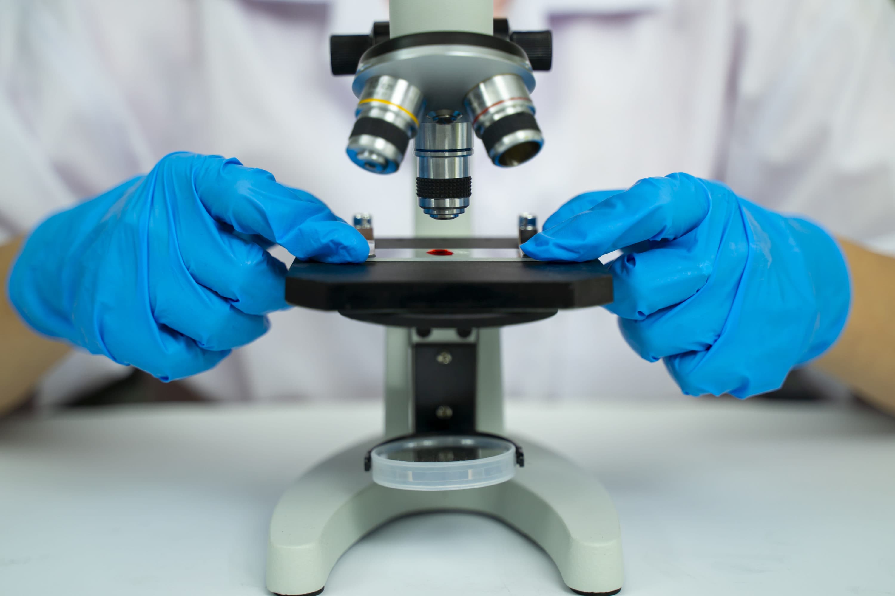 A scientist using a microscope in a laboratory. (Courtesy of Getty Images)