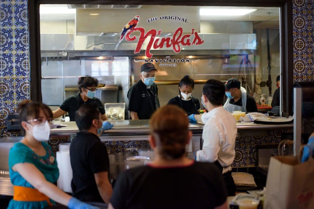 Servers at The Original Ninfa's wear gloves and masks while bringing takeout orders to the kitche amid the novel coronavirus pandemic on May 1, 2020 in Houston, Texas. (Mark Felix/AFP)