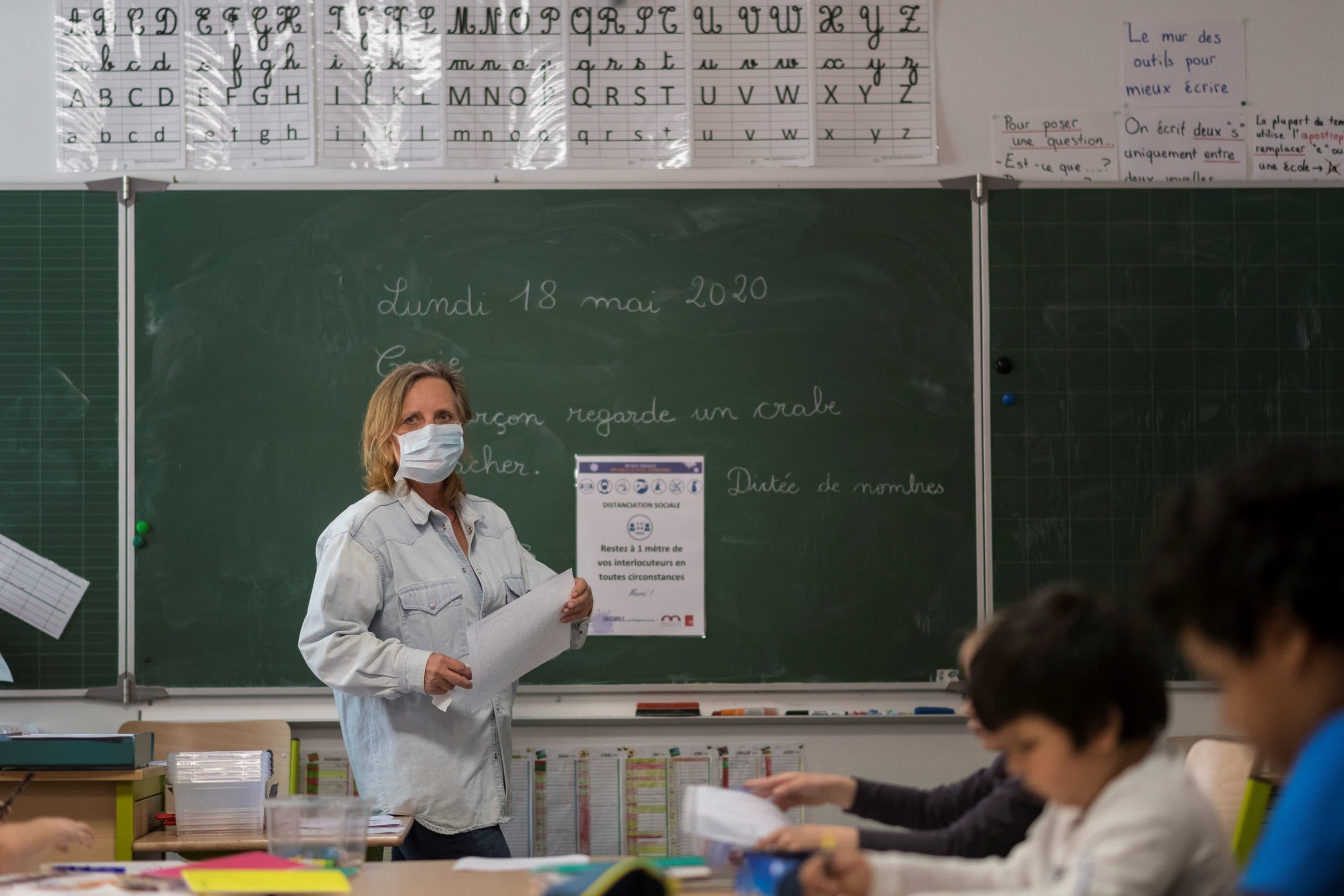 A teacher gives a lesson at the Cour de Lorraine elementary school in Mulhouse, eastern France, on its re-opening day for pupils, on May 18, 2020. (SEBASTIEN BOZON/AFP via Getty Images)