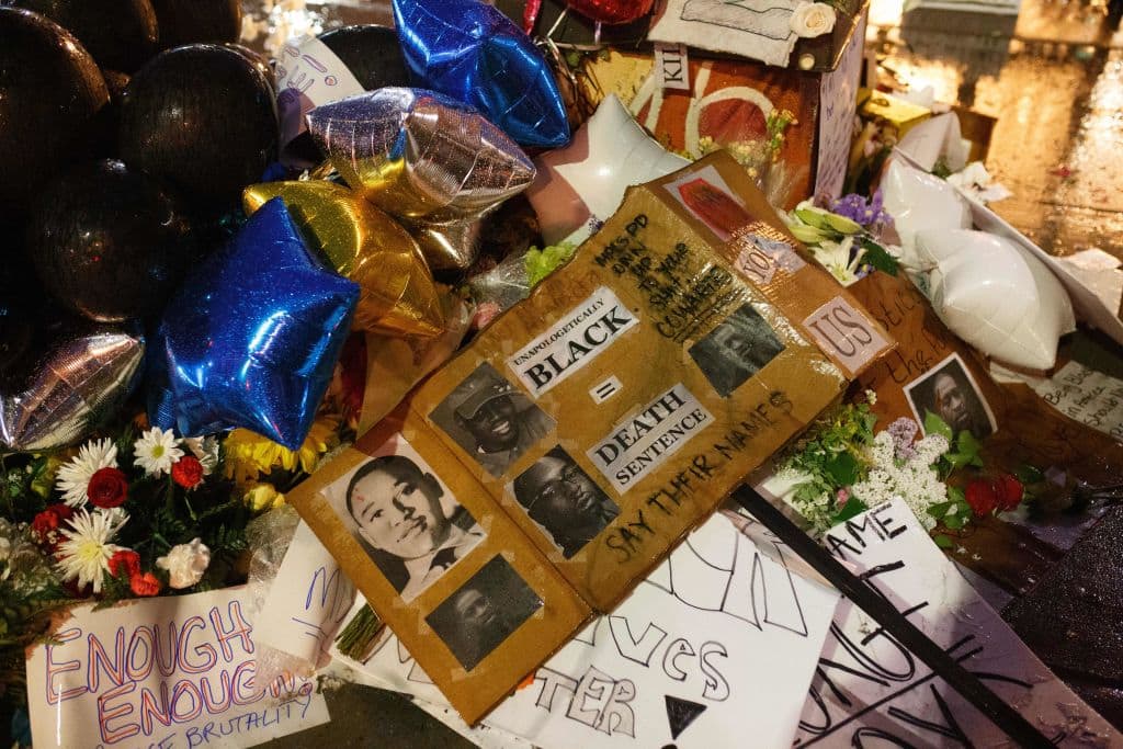 Flowers, signs and balloons are left near a makeshift memorial to George Floyd near the spot where he died while in custody of the Minneapolis Police, on May 26, 2020 in Minneapolis, Minnesota. (Kerem Yucel/AFP/Getty Images)
